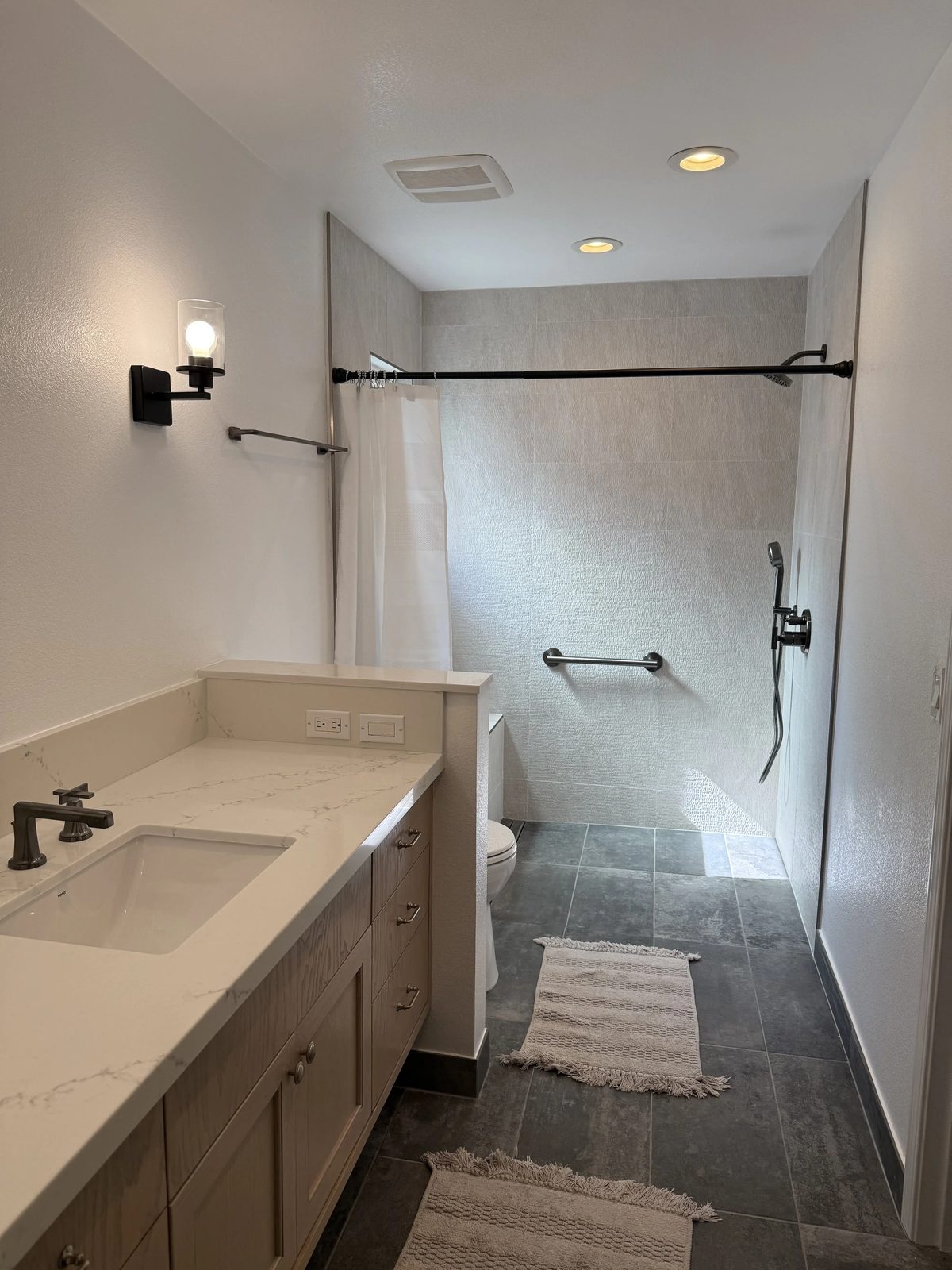 Completed bath renovation with updated lighting